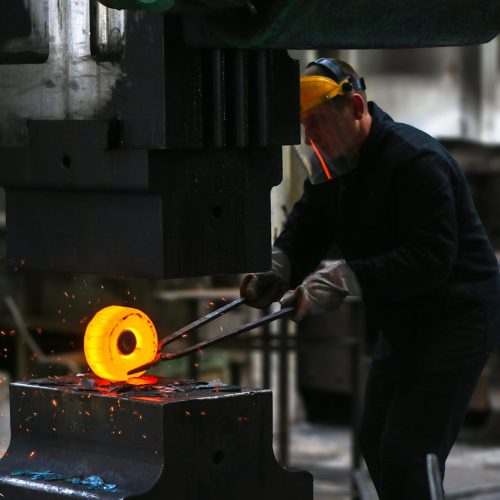 Man Lifting Hot Metal